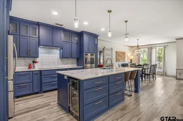 a kitchen with granite countertop wooden cabinets and center island