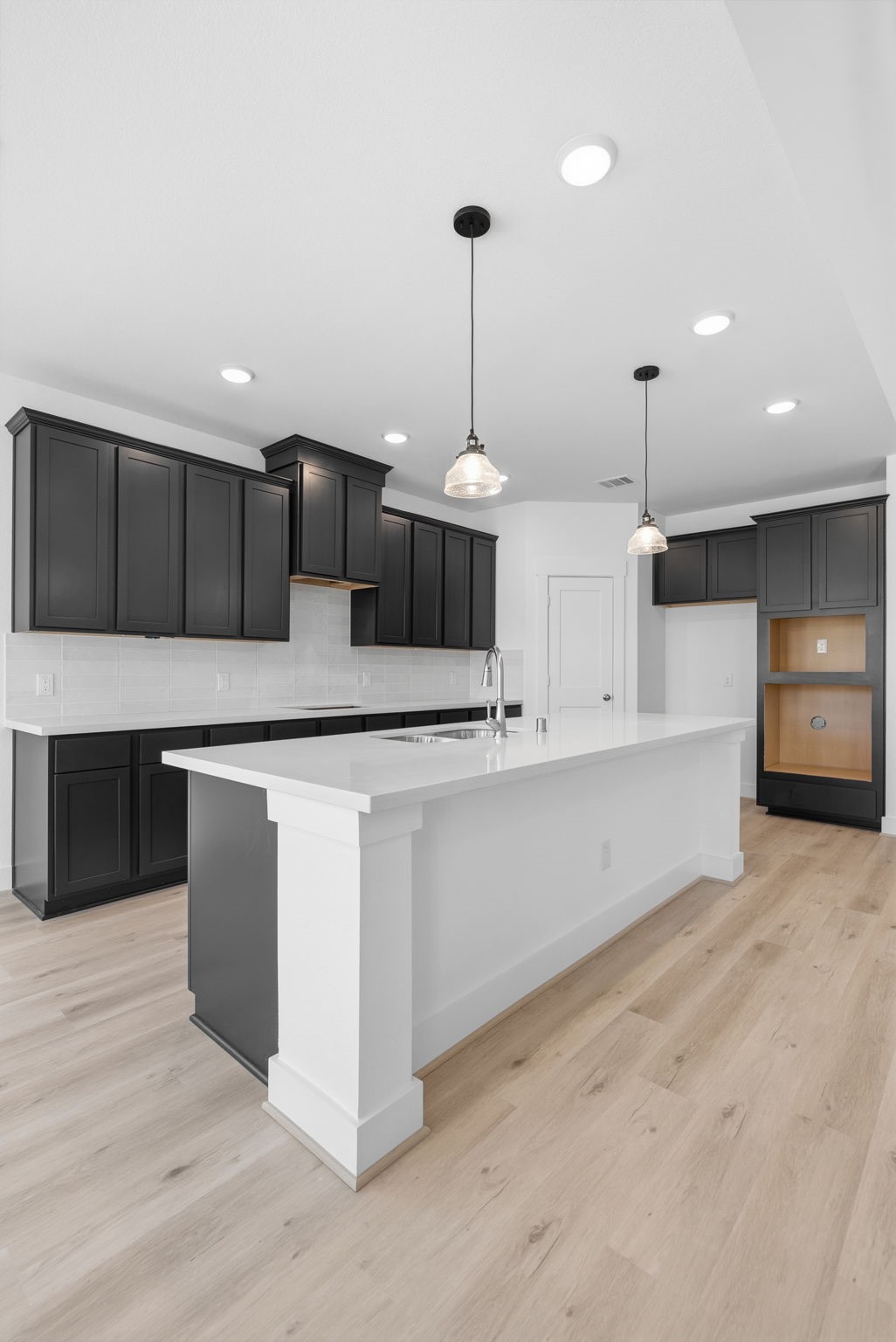 19211 Trinity Terrace Ln Spring Spring, TX 77379 - Photo 19 of 40 a kitchen with stainless steel appliances granite countertop a sink a stove and a wooden floors