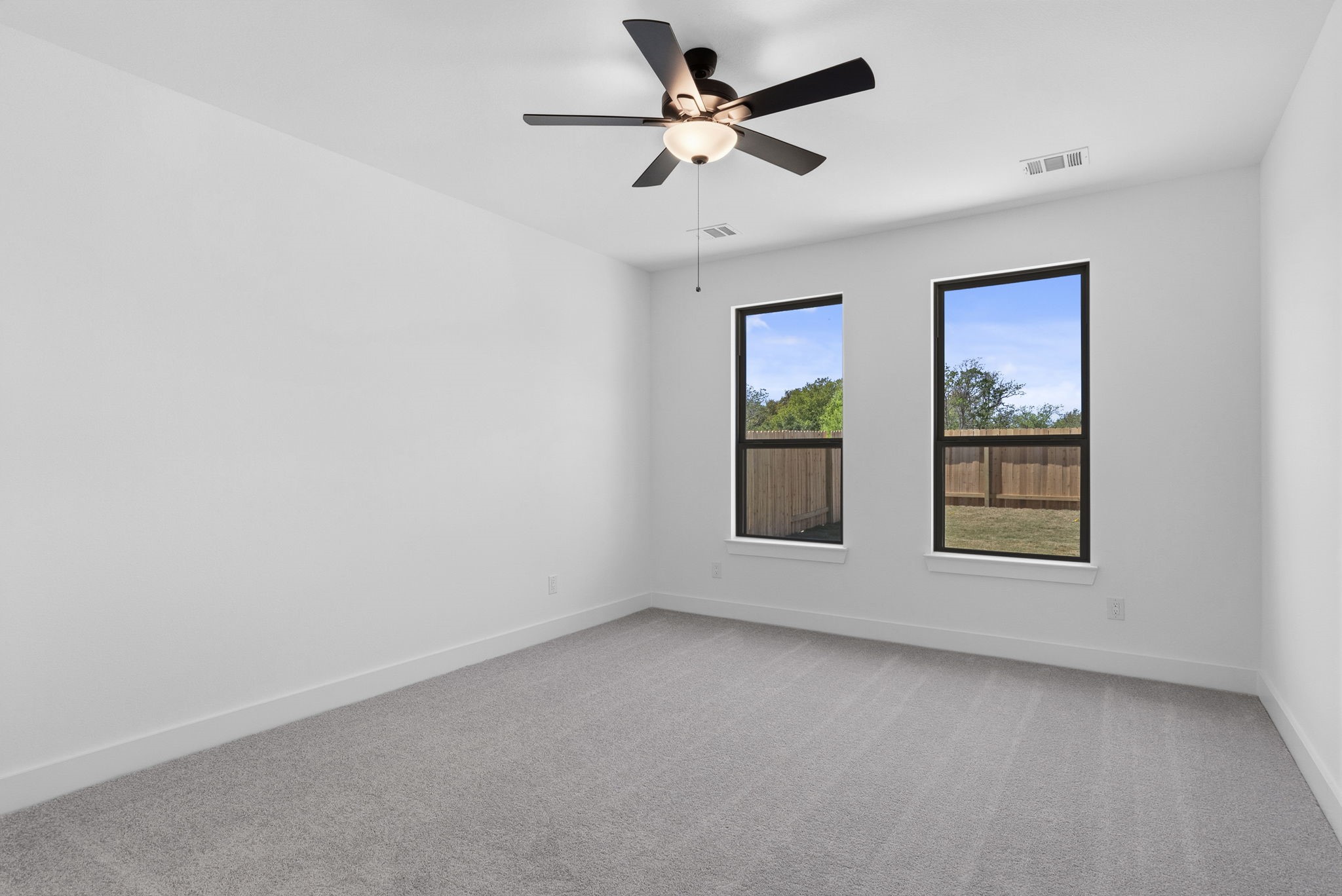 19211 Trinity Terrace Ln Spring Spring, TX 77379 - Photo 22 of 40 an empty room with window and ceiling fan