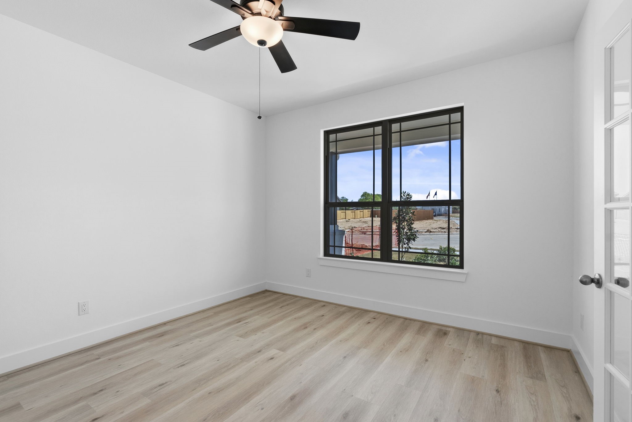 19211 Trinity Terrace Ln Spring Spring, TX 77379 - Photo 5 of 40 an empty room with a window and ceiling fan