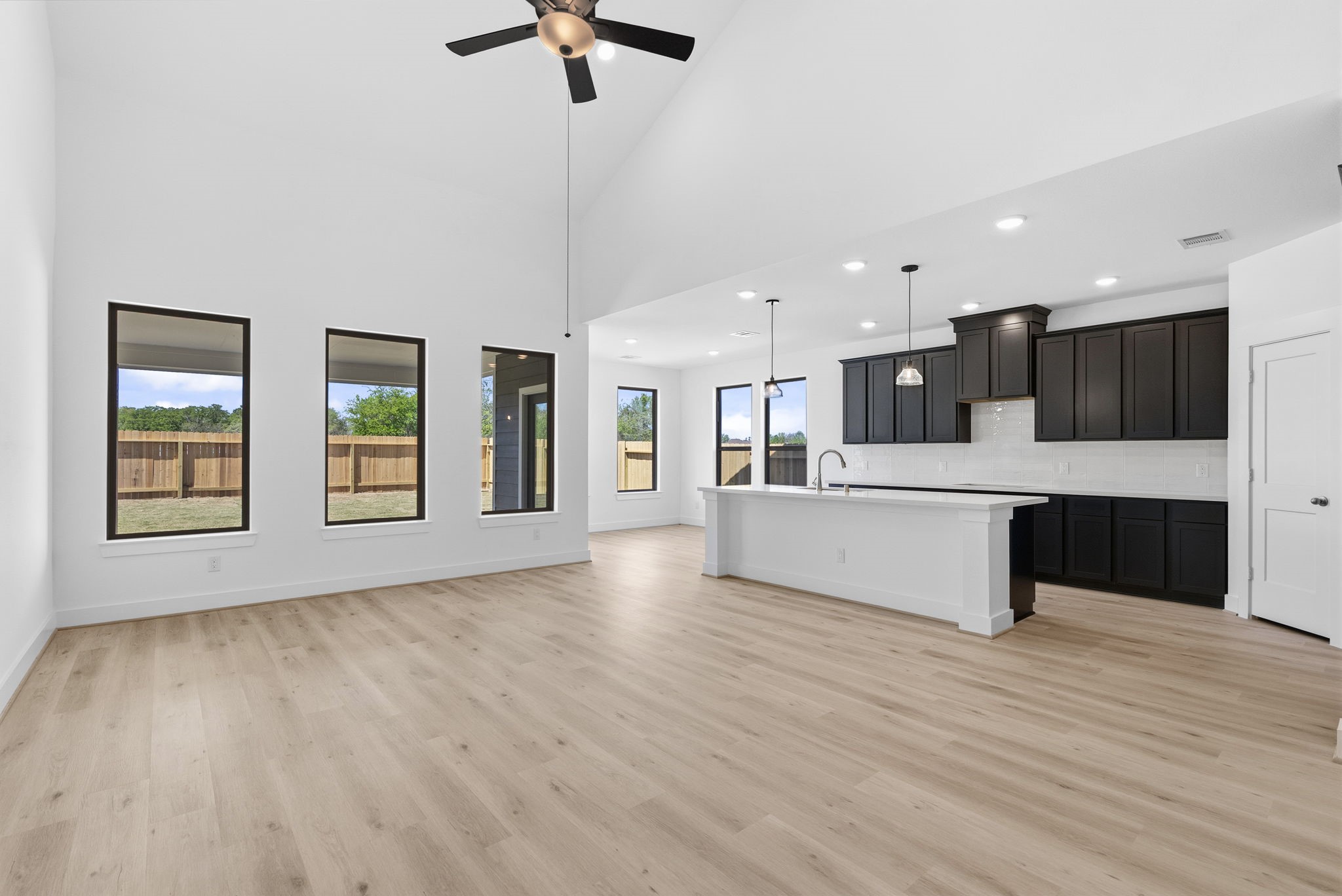 19211 Trinity Terrace Ln Spring Spring, TX 77379 - Photo 9 of 40 a large kitchen with stainless steel appliances kitchen island a large counter top and wooden floors