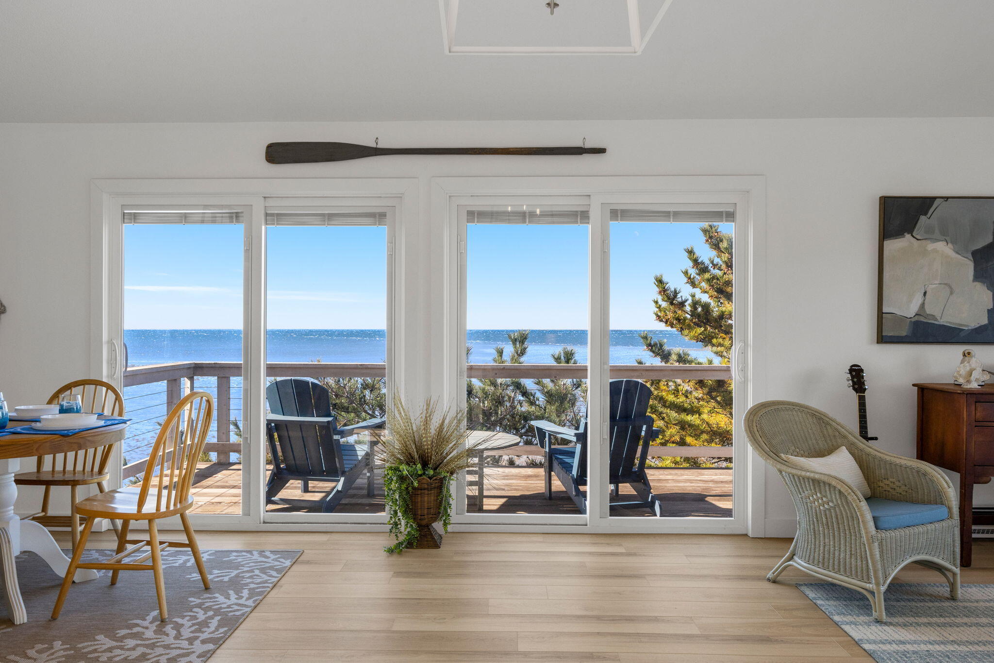 340 Salt Works Road Eastham, MA 02642 - Photo 12 of 52 a living room with fireplace furniture and a floor to ceiling window