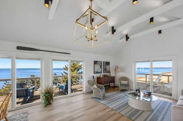 a living room with couch dining table and wooden floor