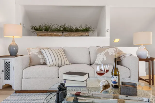 a living room with furniture and a lamp