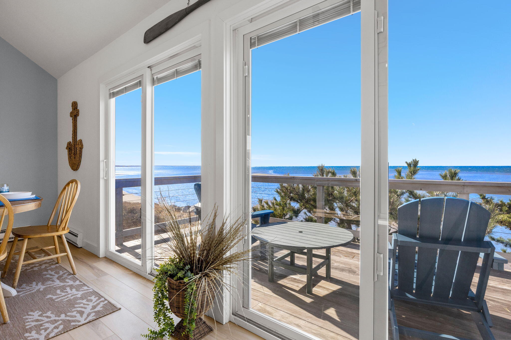340 Salt Works Road Eastham, MA 02642 - Photo 18 of 52 a view of a balcony with table and chairs