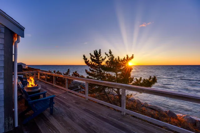 a view of a balcony with chairs and wooden floor