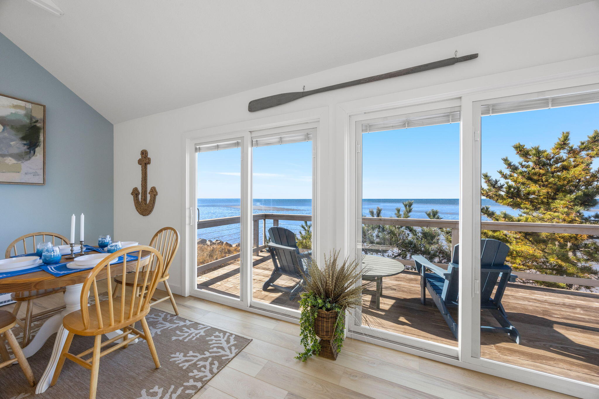 340 Salt Works Road Eastham, MA 02642 - Photo 22 of 52 a dining room with furniture and a floor to ceiling window