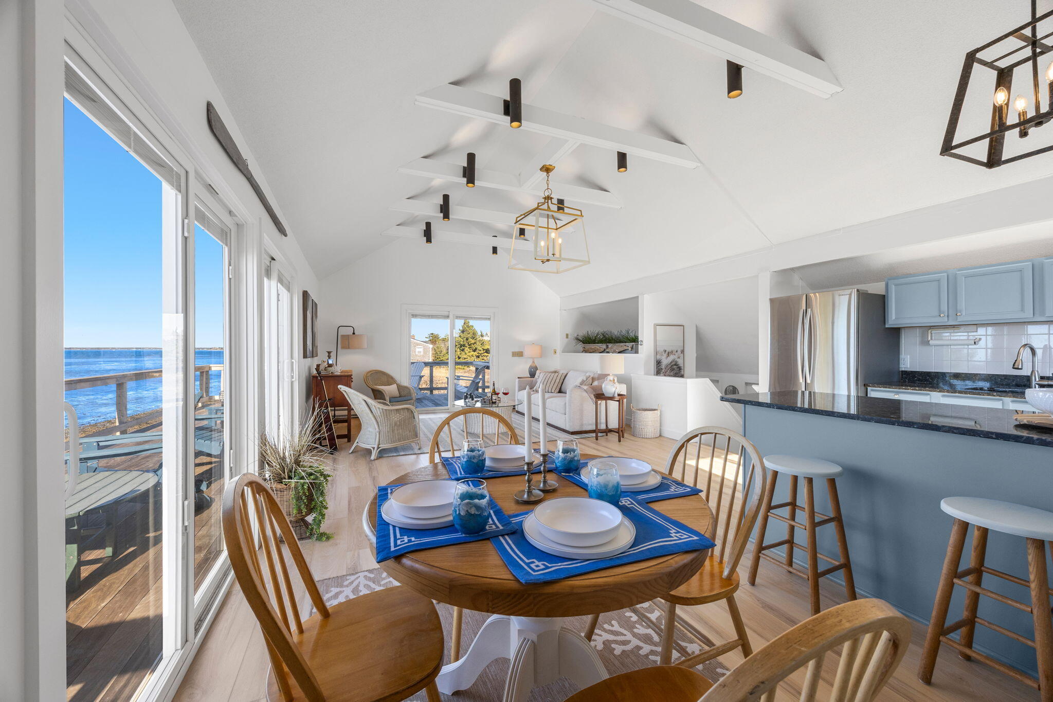340 Salt Works Road Eastham, MA 02642 - Photo 23 of 52 a view of a dining room with furniture a kitchen and chandelier