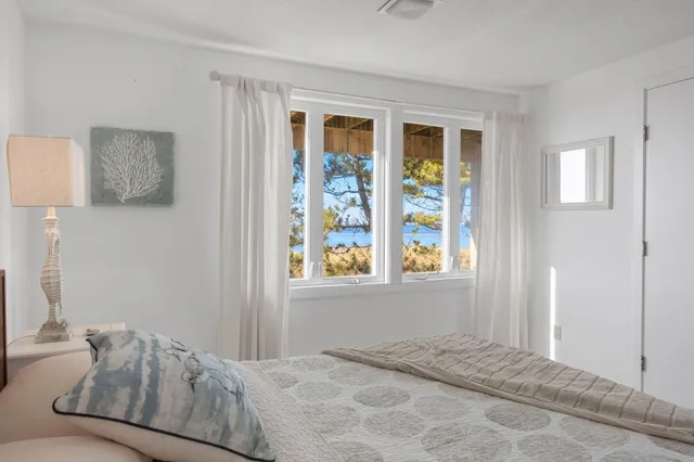 a bedroom with a bed and painting on the wall