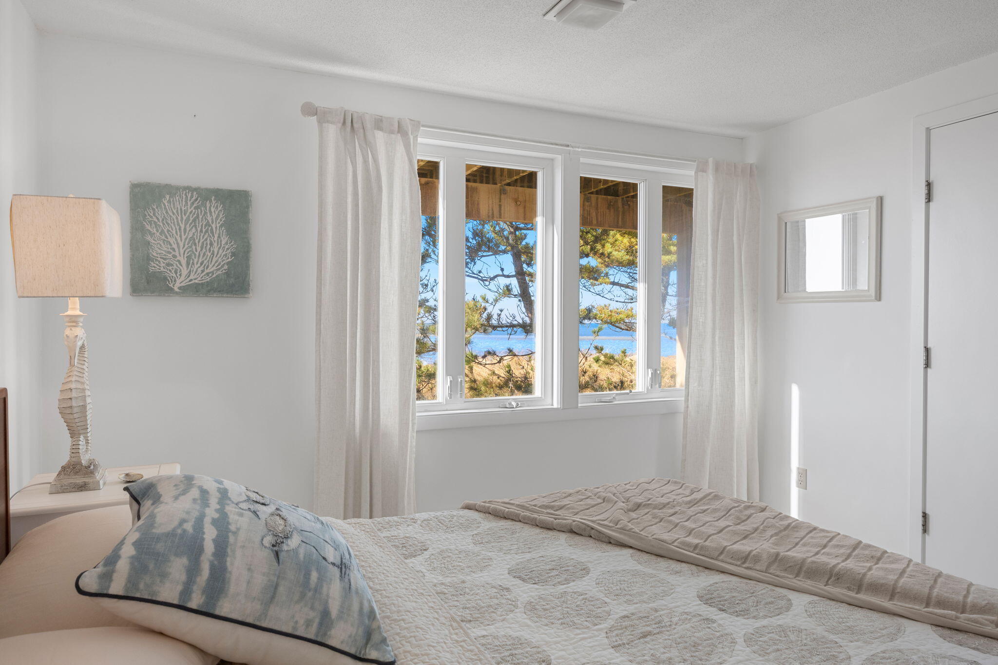 340 Salt Works Road Eastham, MA 02642 - Photo 32 of 52 a bedroom with a bed and a window