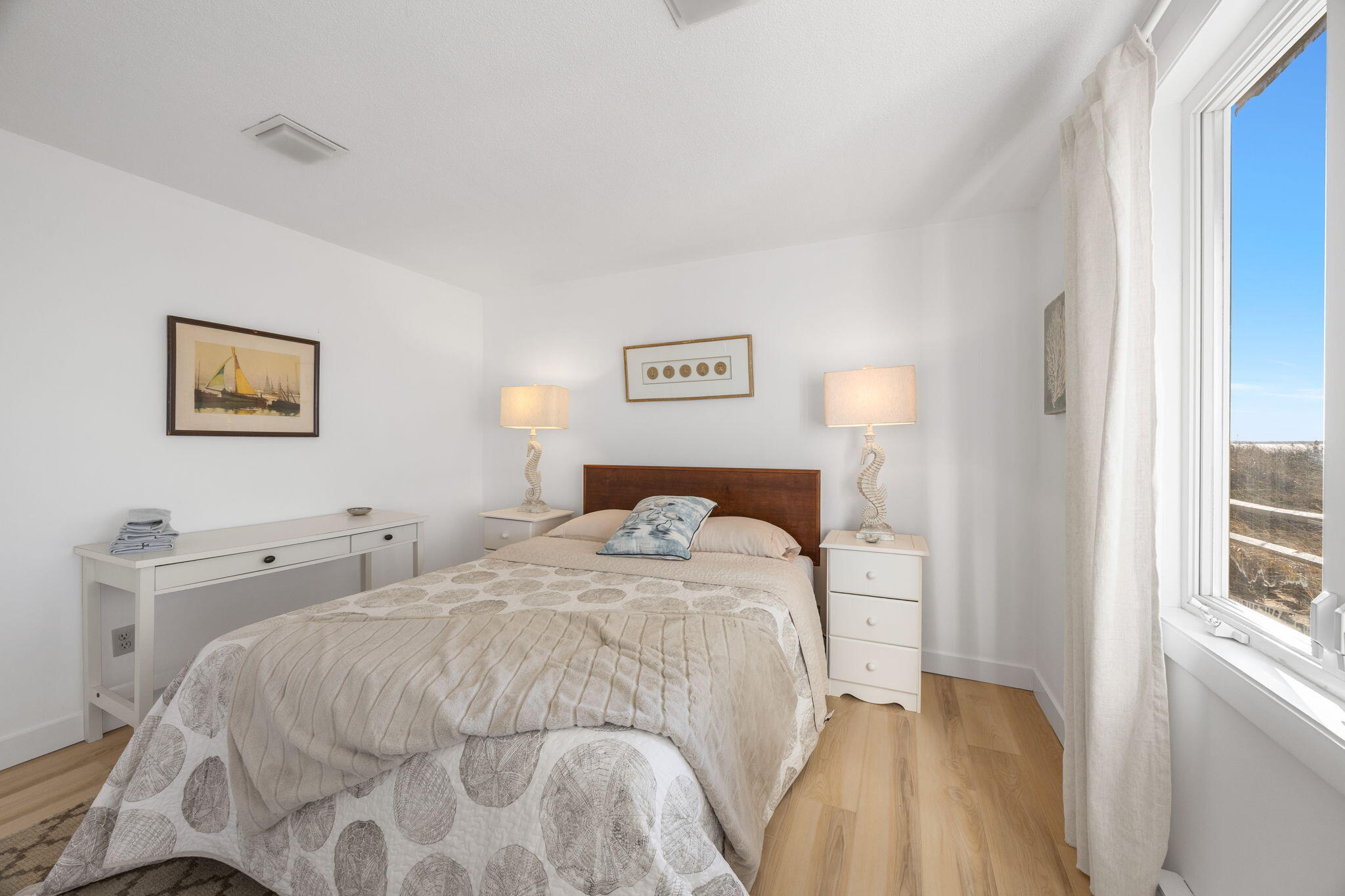 340 Salt Works Road Eastham, MA 02642 - Photo 33 of 52 a bedroom with a bed and painting on the wall