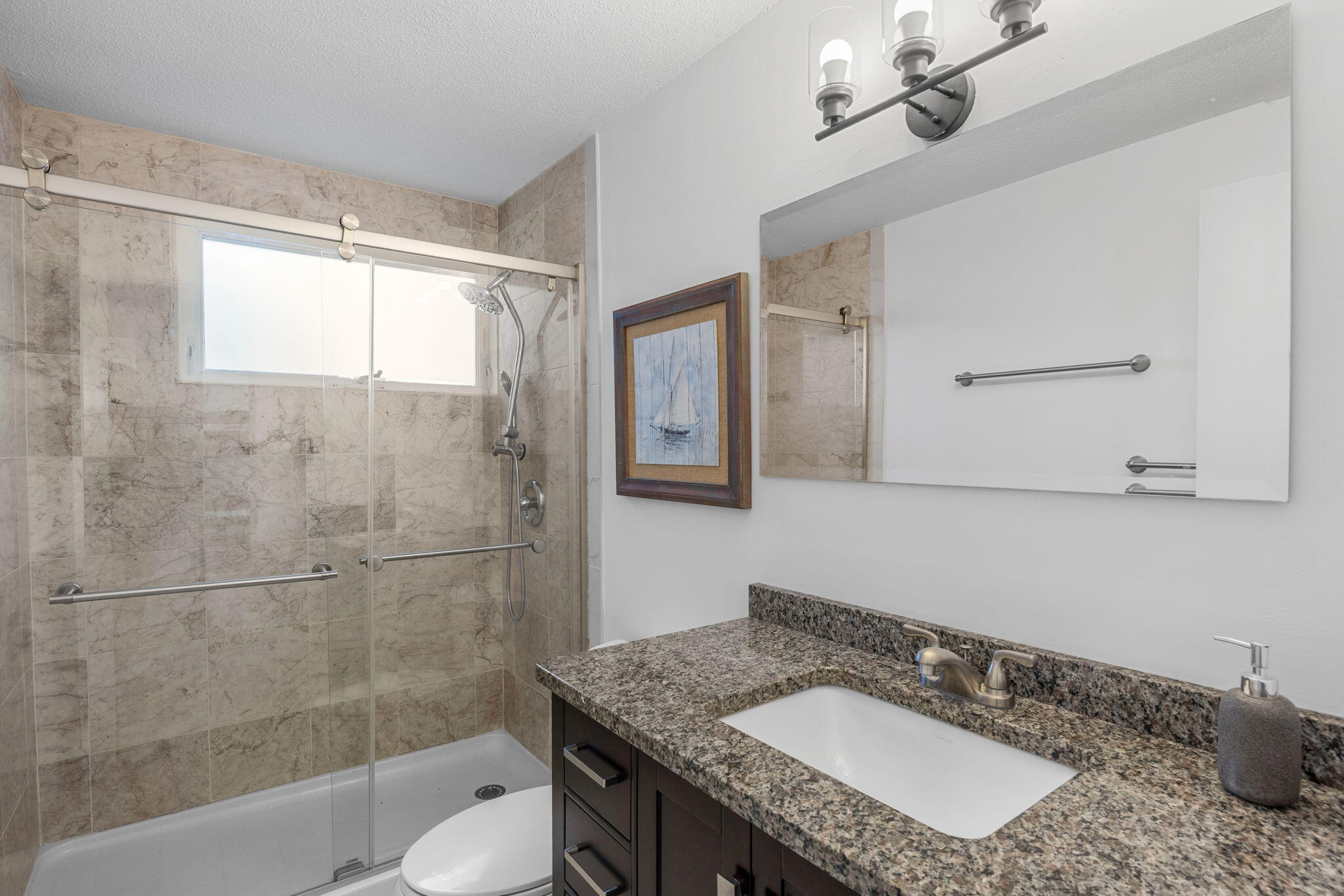 340 Salt Works Road Eastham, MA 02642 - Photo 34 of 52 a bathroom with a granite countertop sink a mirror and a bathtub