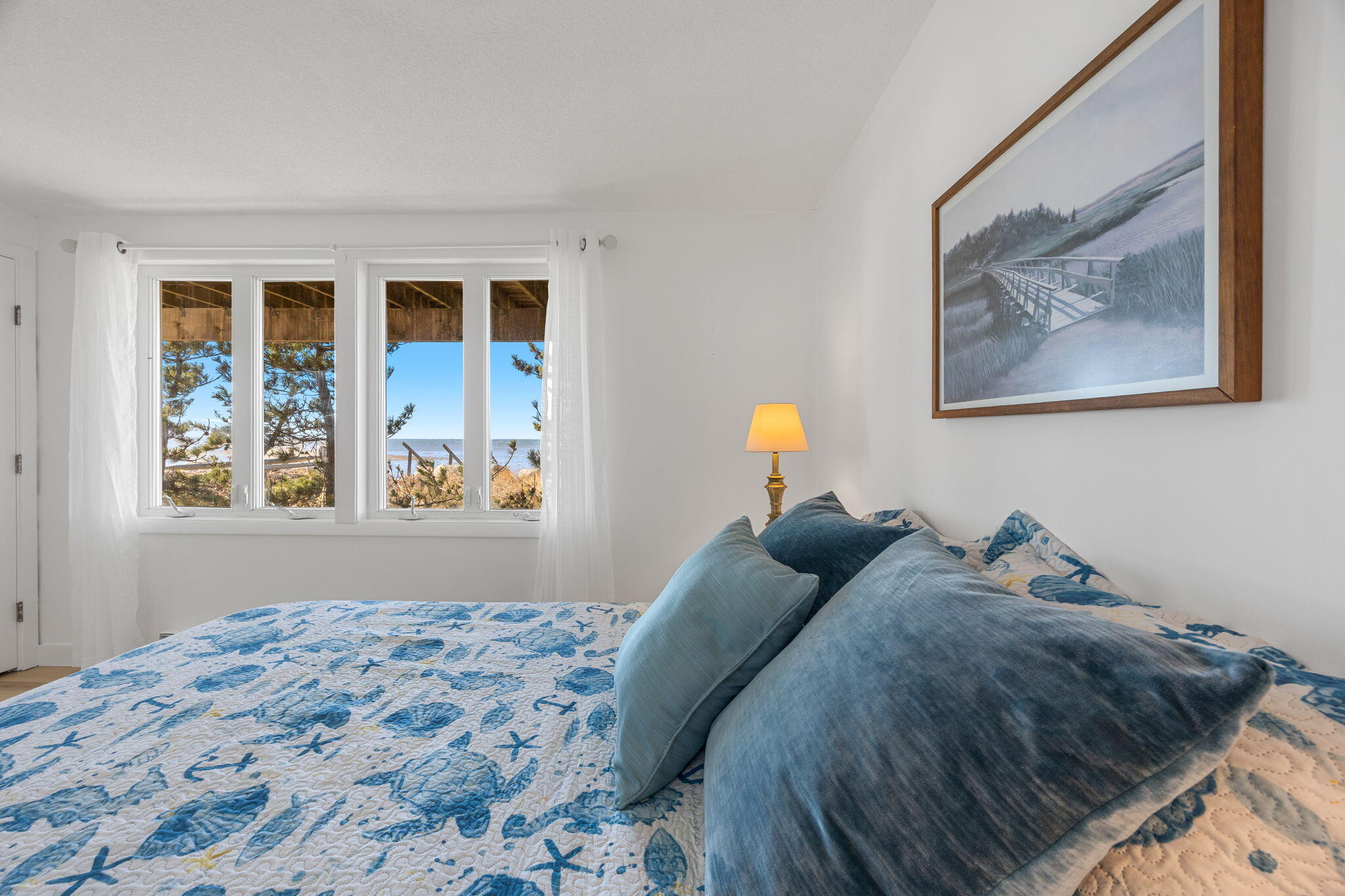 340 Salt Works Road Eastham, MA 02642 - Photo 37 of 52 a bedroom with a bed and a painting on the wall