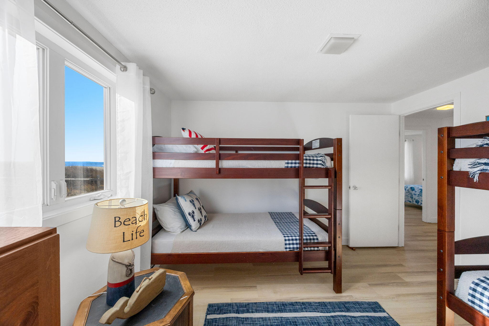 340 Salt Works Road Eastham, MA 02642 - Photo 38 of 52 a bedroom with a bed and wooden floor