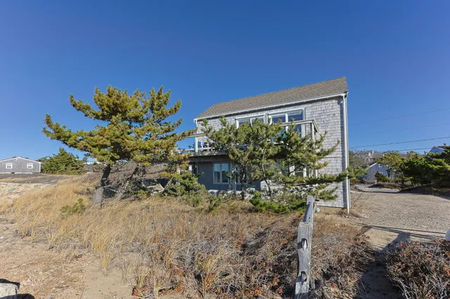 a view of a chairs and table in patio with wooden fence