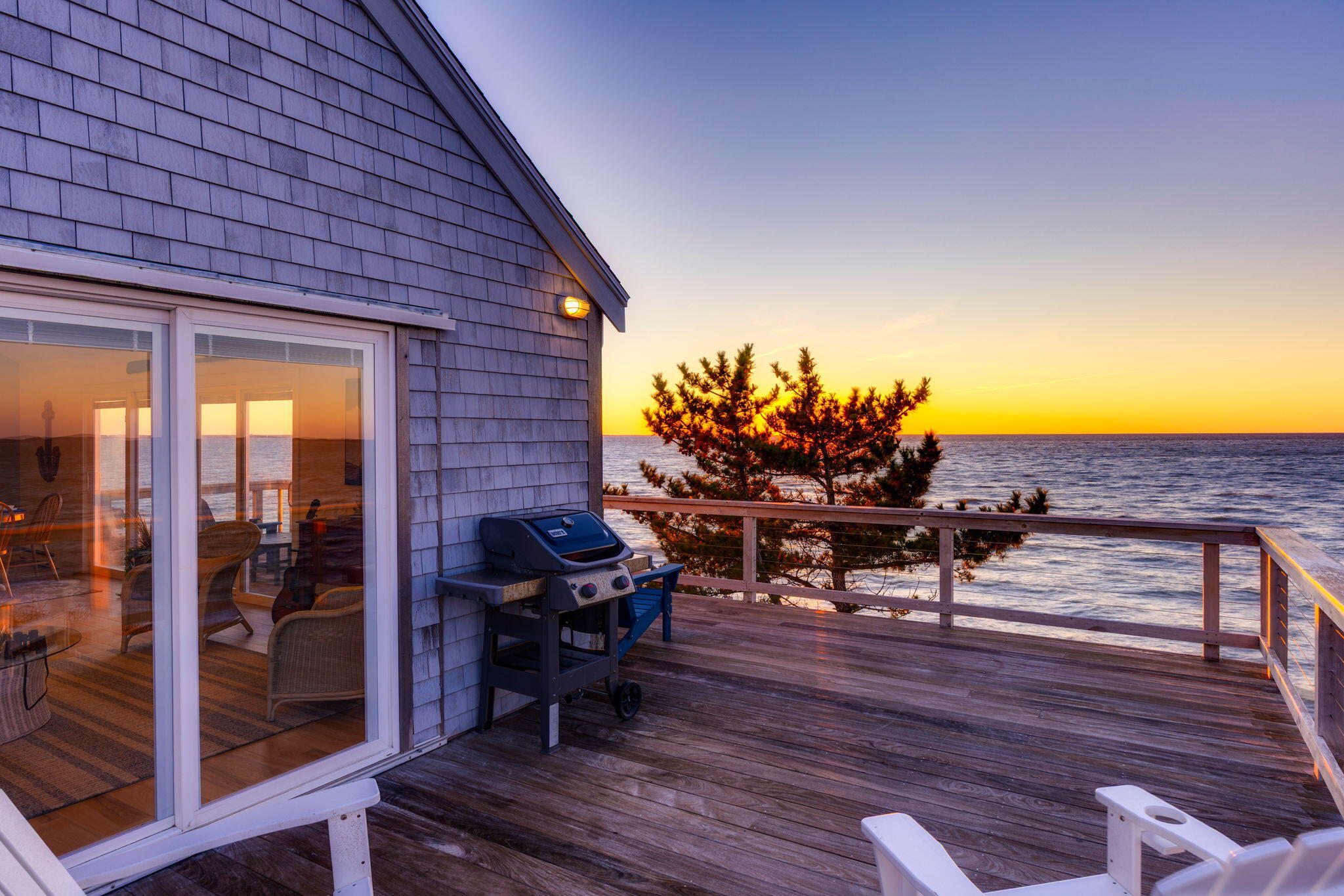 340 Salt Works Road Eastham, MA 02642 - Photo 45 of 52 a view of a chairs and table in patio with wooden fence