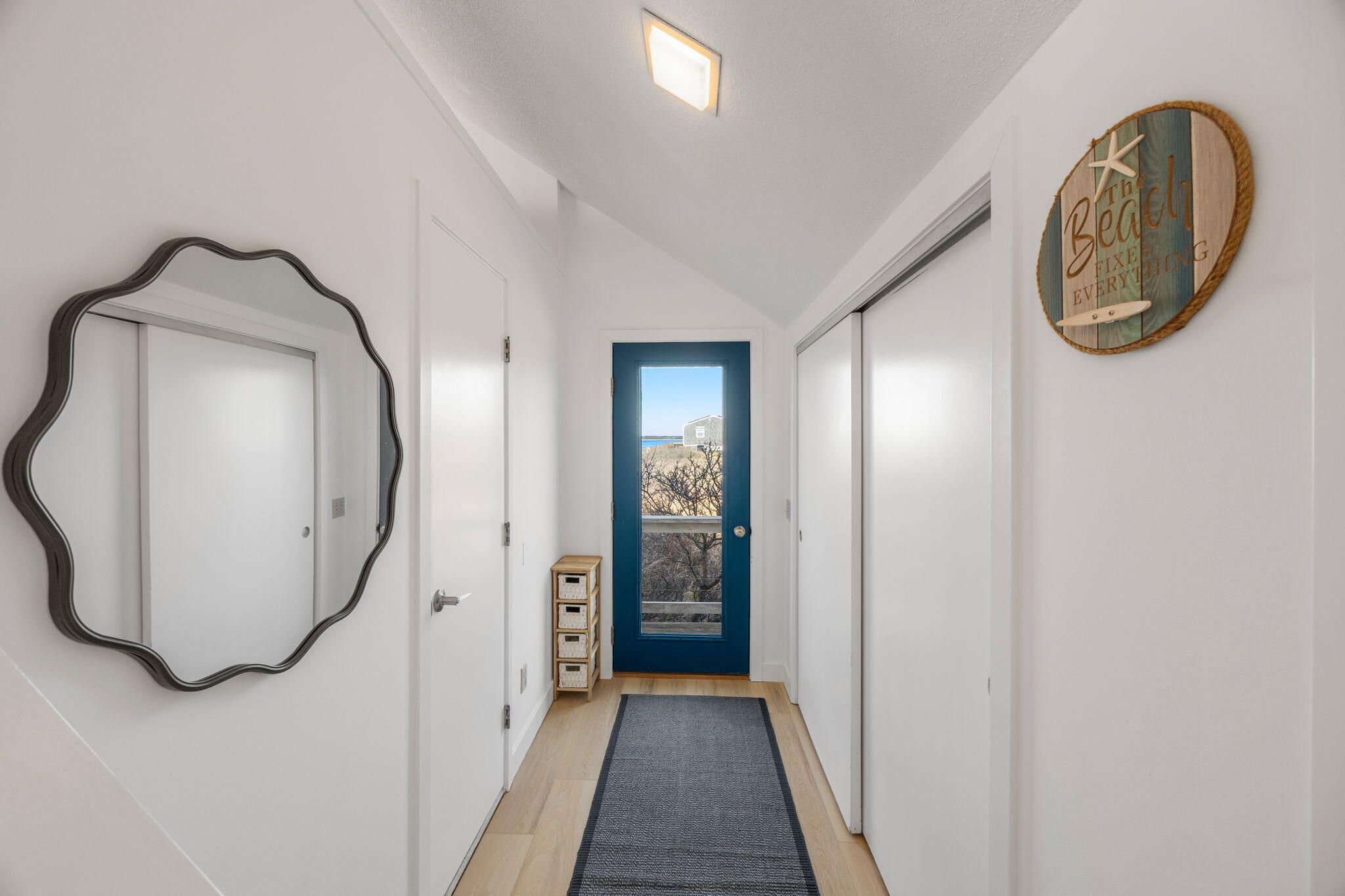 340 Salt Works Road Eastham, MA 02642 - Photo 8 of 52 a view of a livingroom with wooden floor and a mirror
