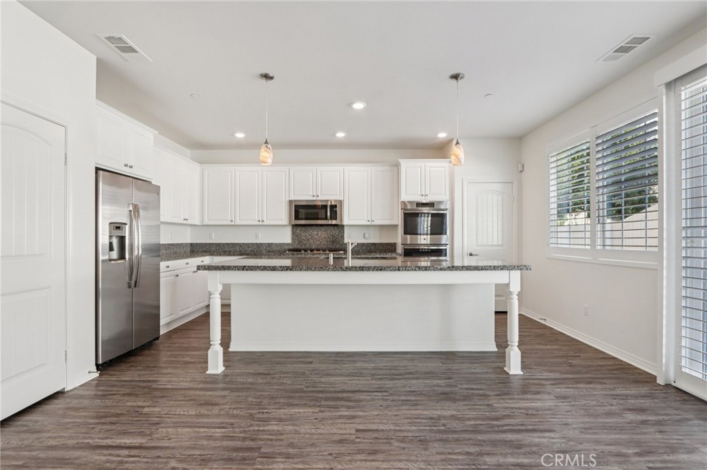 29594 Chelton Way Menifee, CA 92584 - Photo 15 of 48 a kitchen with stainless steel appliances granite countertop a refrigerator and a stove top oven