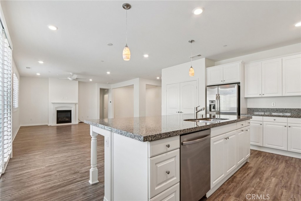 29594 Chelton Way Menifee, CA 92584 - Photo 16 of 48 a kitchen with a sink stainless steel appliances and white cabinets