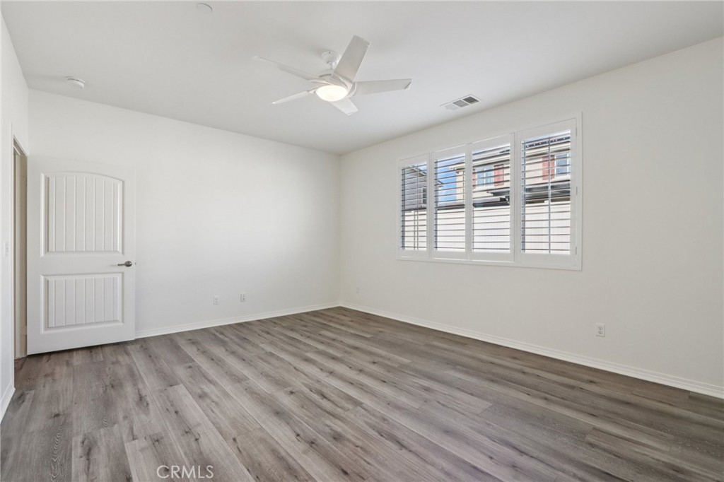 29594 Chelton Way Menifee, CA 92584 - Photo 18 of 48 wooden floor in an empty room with a window