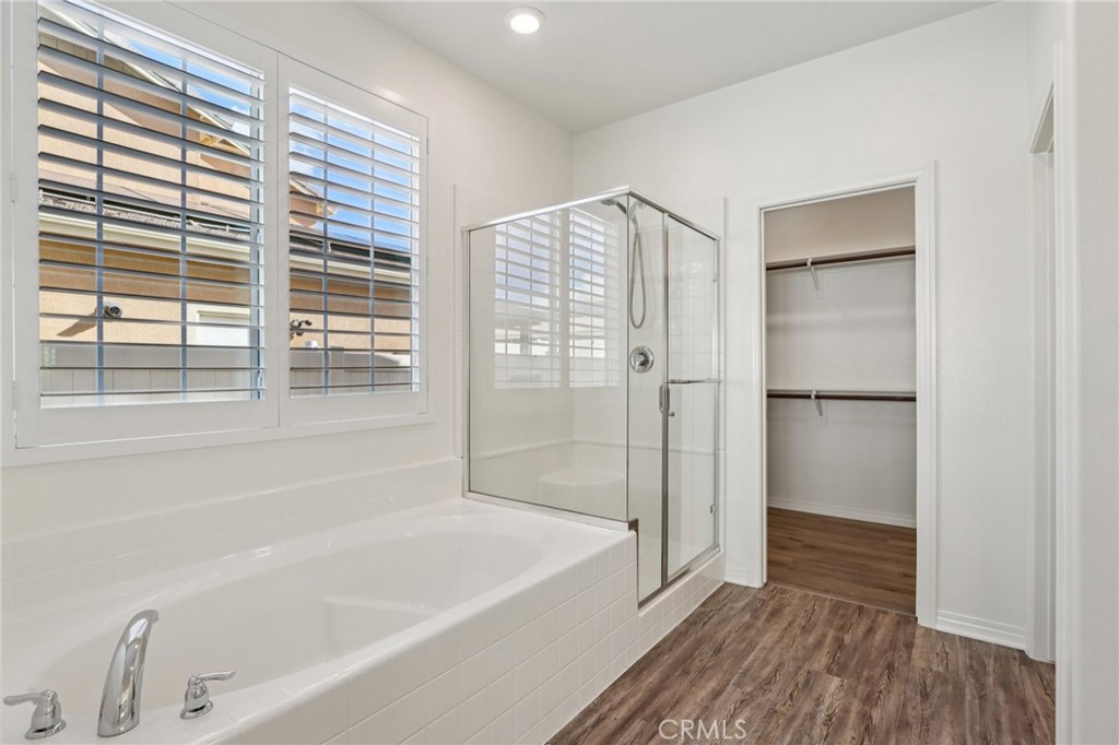 29594 Chelton Way Menifee, CA 92584 - Photo 20 of 48 a bathroom with a bathtub and a shower