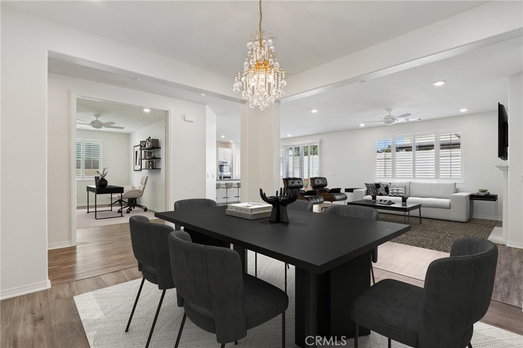 29594 Chelton Way Menifee, CA 92584 - Photo 2 of 48 a view of a a dining room and livingroom furniture a rug a chandelier and wooden floor