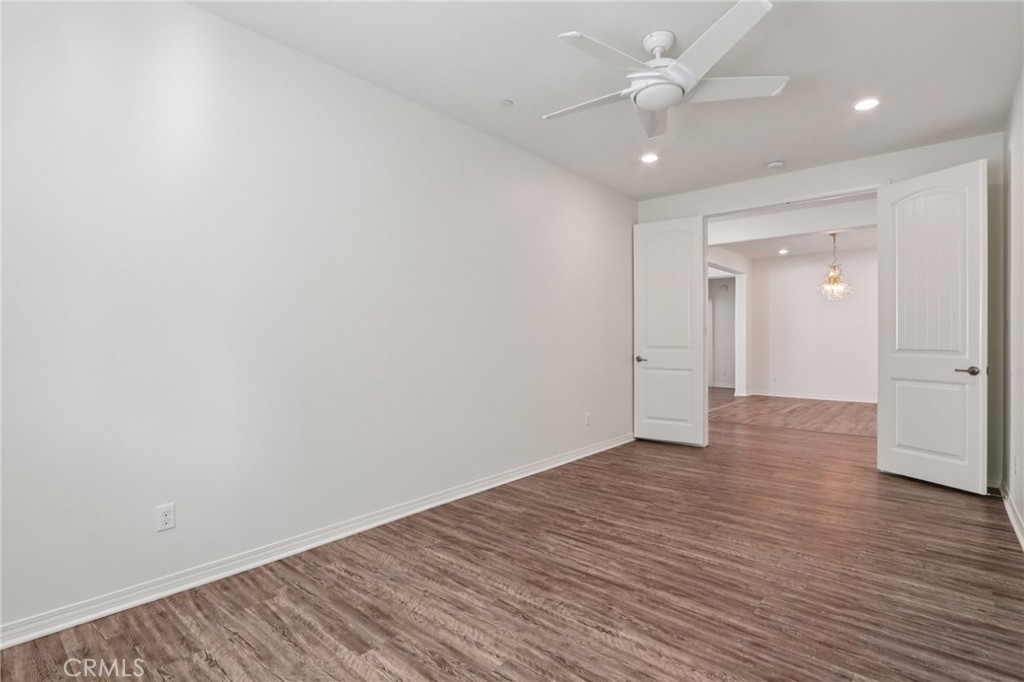 29594 Chelton Way Menifee, CA 92584 - Photo 25 of 48 a view of an empty room and wooden floor