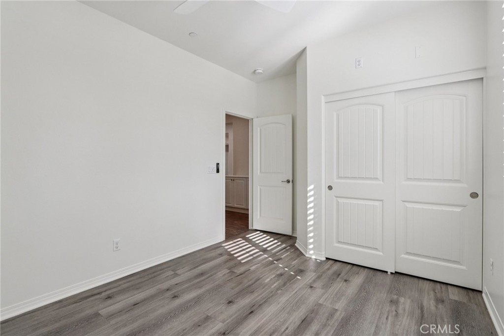 29594 Chelton Way Menifee, CA 92584 - Photo 29 of 48 a view of an empty room with wooden floor