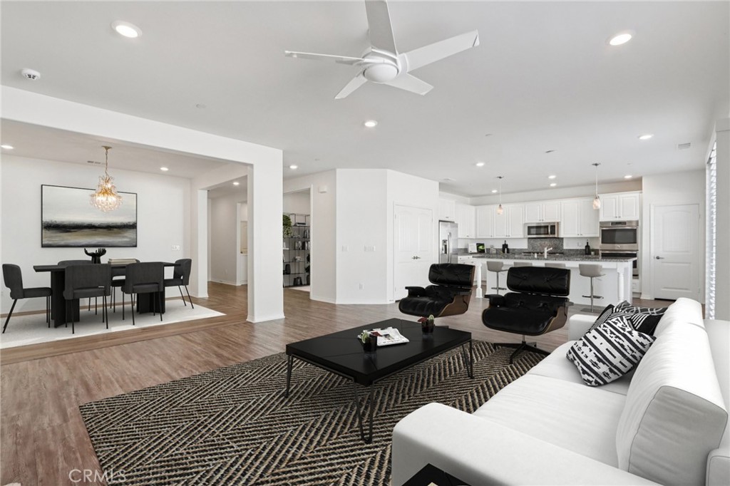 29594 Chelton Way Menifee, CA 92584 - Photo 4 of 48 a living room with furniture kitchen view and a wooden floor