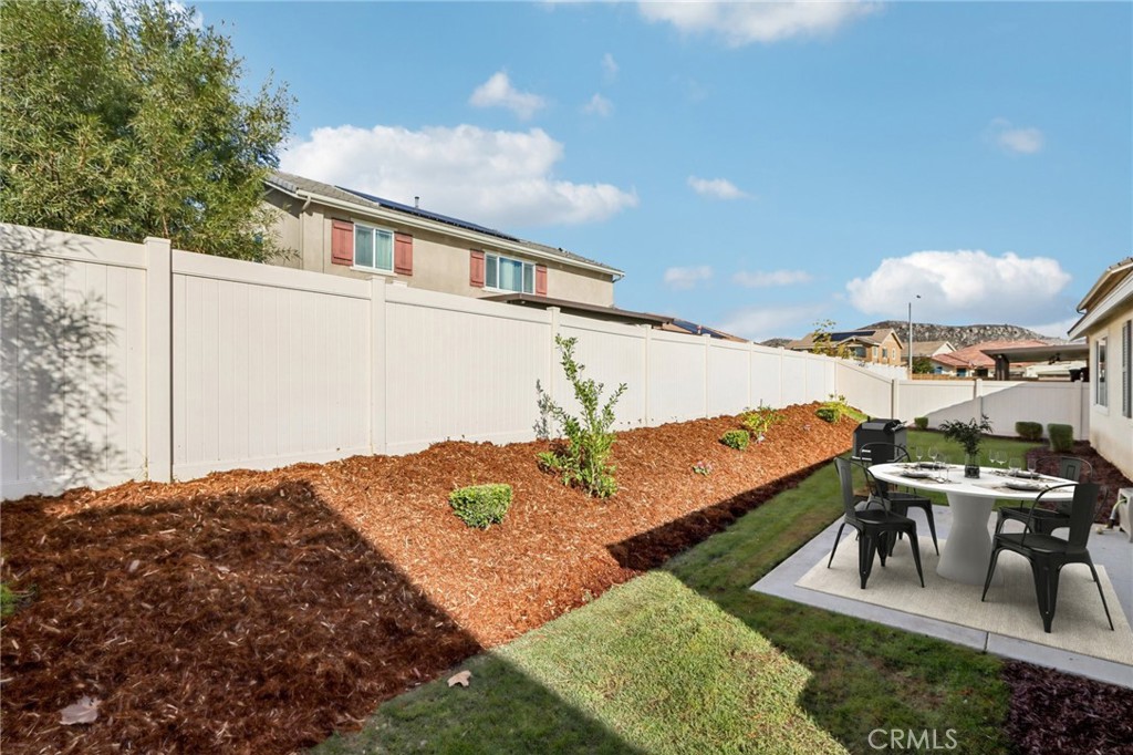 29594 Chelton Way Menifee, CA 92584 - Photo 6 of 48 a view of a patio with a table and chairs