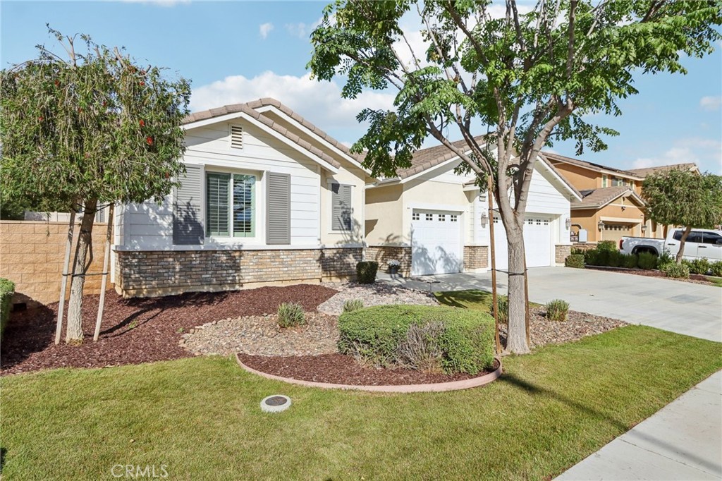 29594 Chelton Way Menifee, CA 92584 - Photo 8 of 48 a view of a white house next to a yard and trees