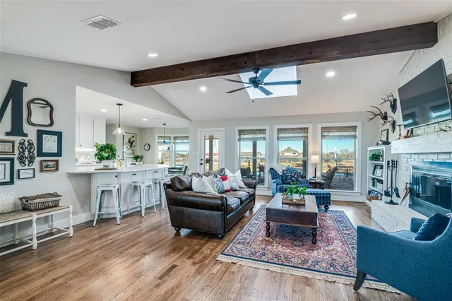 a living room with fireplace furniture and a flat screen tv