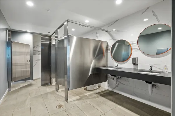 a kitchen with stainless steel appliances a sink a stove a refrigerator and cabinets