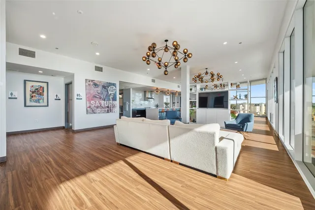 a living room with furniture fireplace and wooden floor