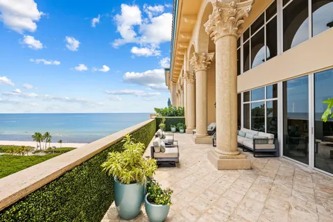 a view of balcony with couch and potted plants