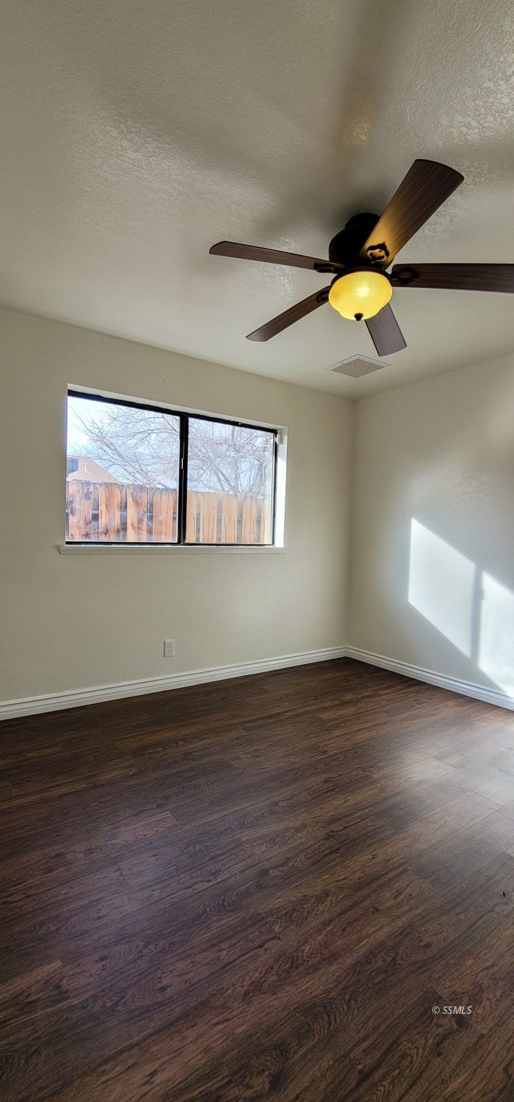 544 Weiman Avenue Ridgecrest, CA 93555 - Photo 13 of 20 a view of an empty room with wooden floor and a window