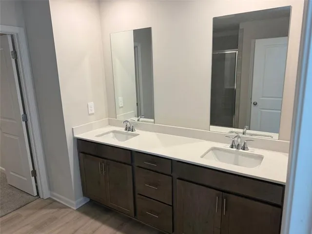a bathroom with a double vanity sink and a mirror