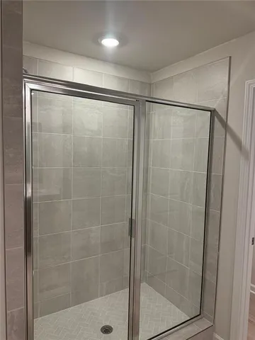 a bathroom with a glass shower door