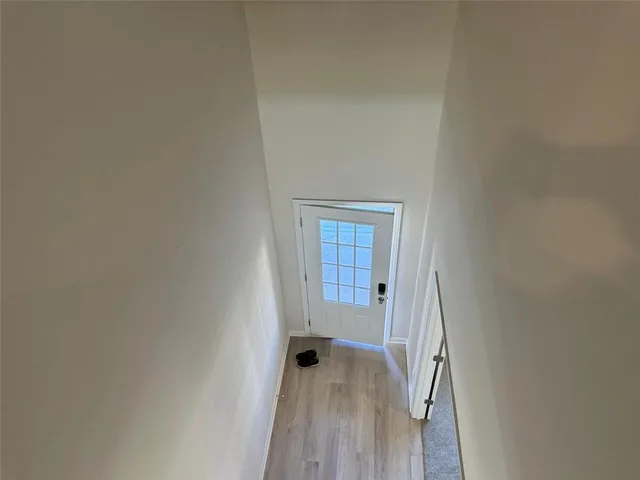 a view of a hallway with wooden floor