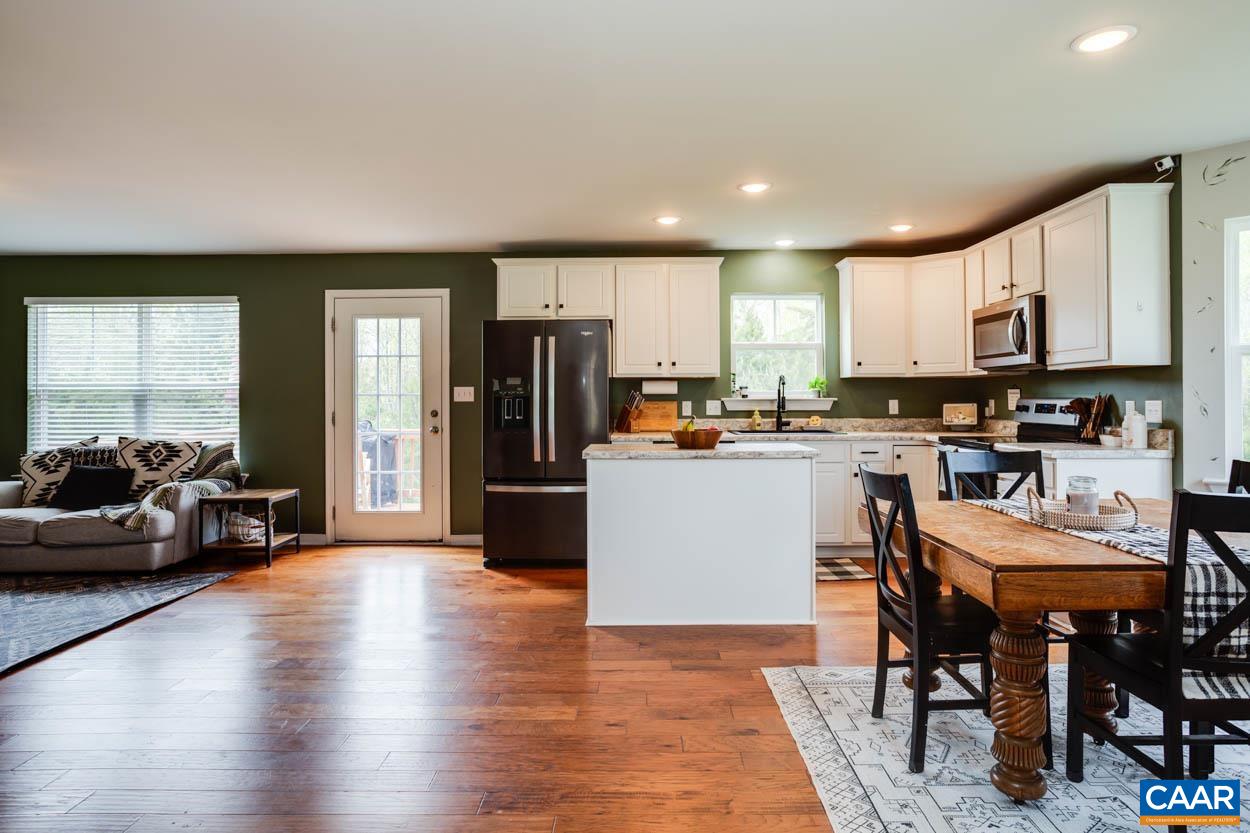 1090 Briery Farm Road Scottsville, VA 24590 - Photo 5 of 30 a kitchen with a table chairs refrigerator and cabinets