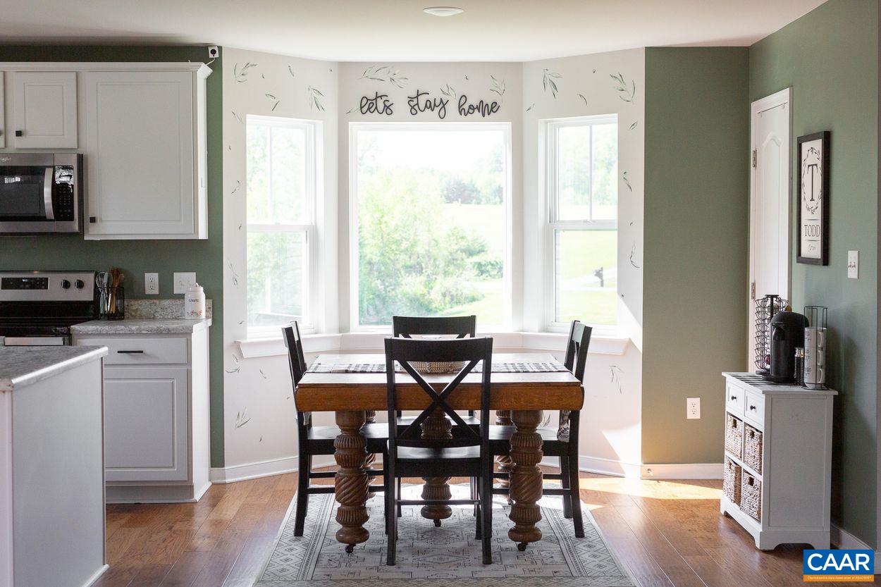 1090 Briery Farm Road Scottsville, VA 24590 - Photo 7 of 30 a view of a dining room with furniture and wooden floor