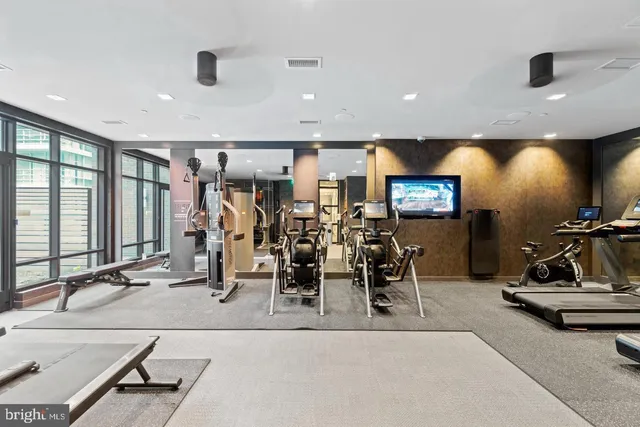 a living room with stainless steel appliances kitchen island granite countertop furniture and a large window