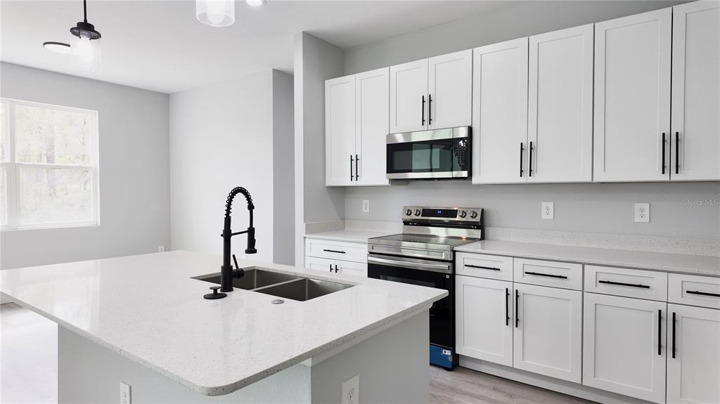 7 Spring Pass Ocala, FL 34472 - Photo 28 of 35 a kitchen with white cabinets and stainless steel appliances