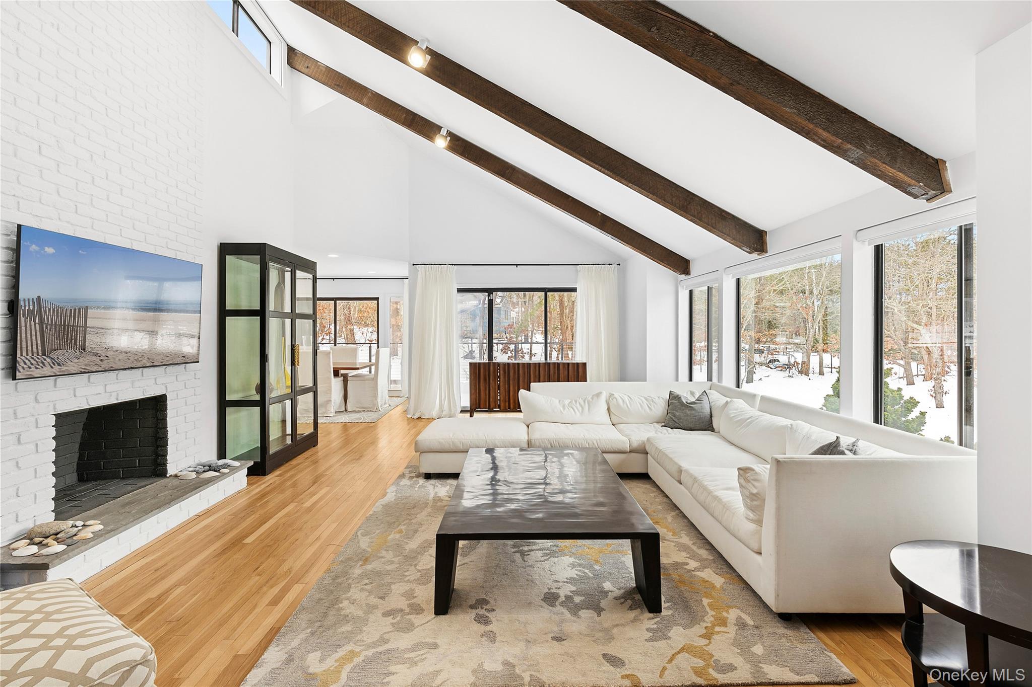 138 Longview Road Southampton, NY 11968 - Photo 2 of 13 a living room with furniture fireplace and flat screen tv