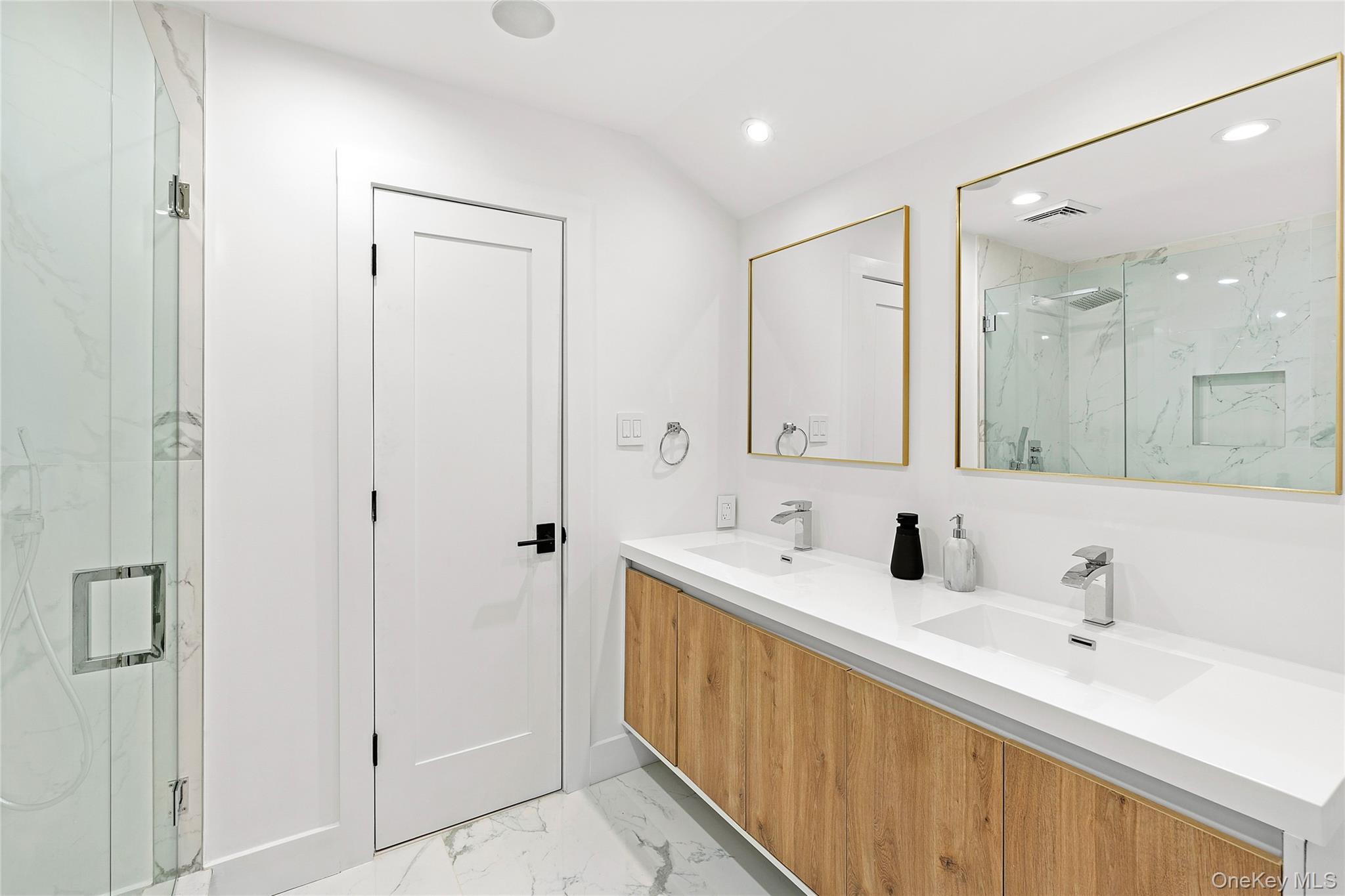 138 Longview Road Southampton, NY 11968 - Photo 6 of 13 a bathroom with a double vanity sink mirror and