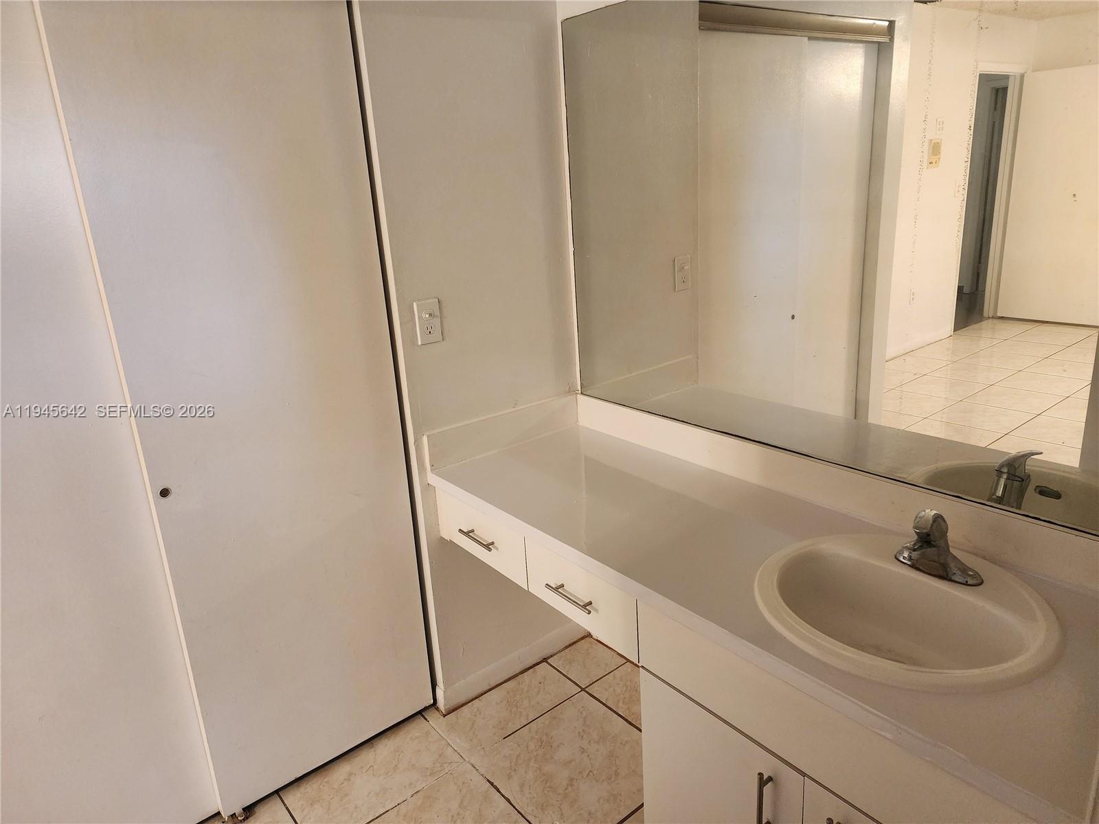 9863 Southwest 117th Place Miami, FL 33186 - Photo 16 of 29 a bathroom with a sink and a mirror