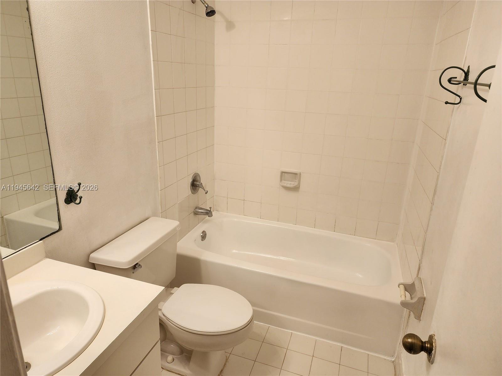 9863 Southwest 117th Place Miami, FL 33186 - Photo 19 of 29 a bathroom with a sink a toilet and a bathtub