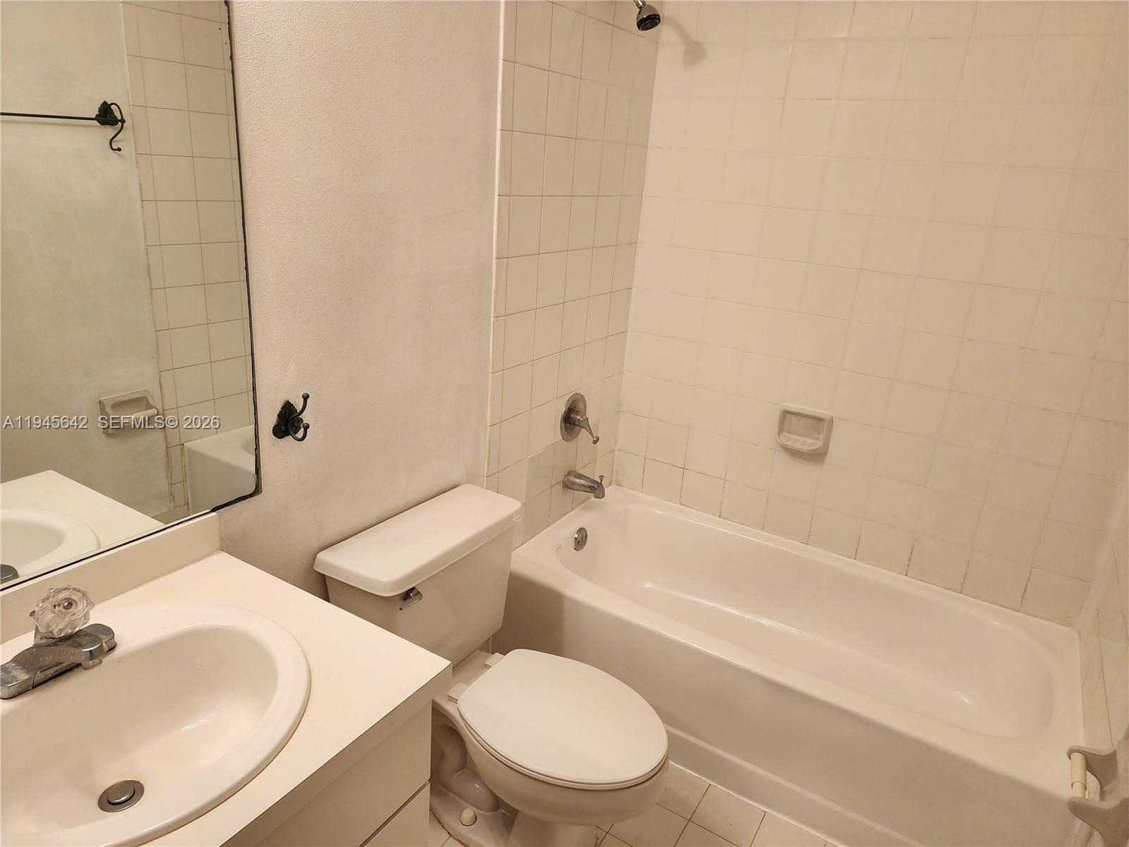 9863 Southwest 117th Place Miami, FL 33186 - Photo 20 of 29 a white toilet and tub sitting next to a bathroom sink