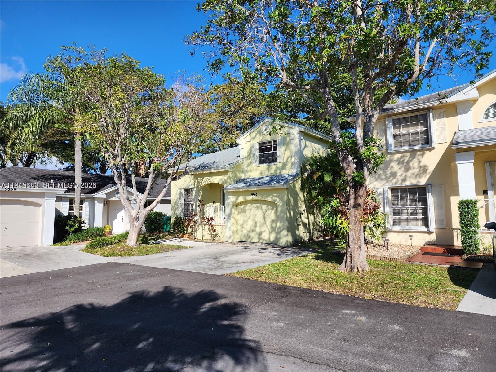 9863 Southwest 117th Place Miami, FL 33186 - Photo 3 of 29 a view of a street with houses on both side