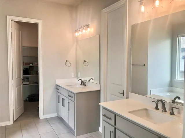 a bathroom with a sink double vanity and a mirror